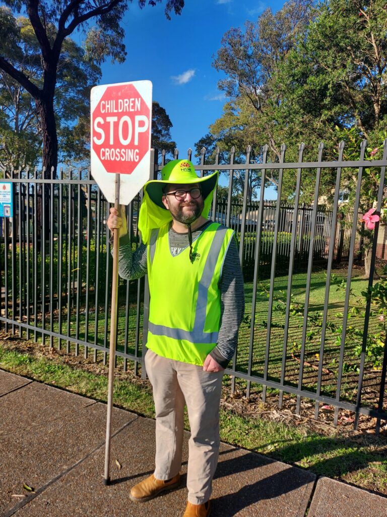 uLaunch - photo of a man wearing hi-vis holding a Stop - children crossing sign
