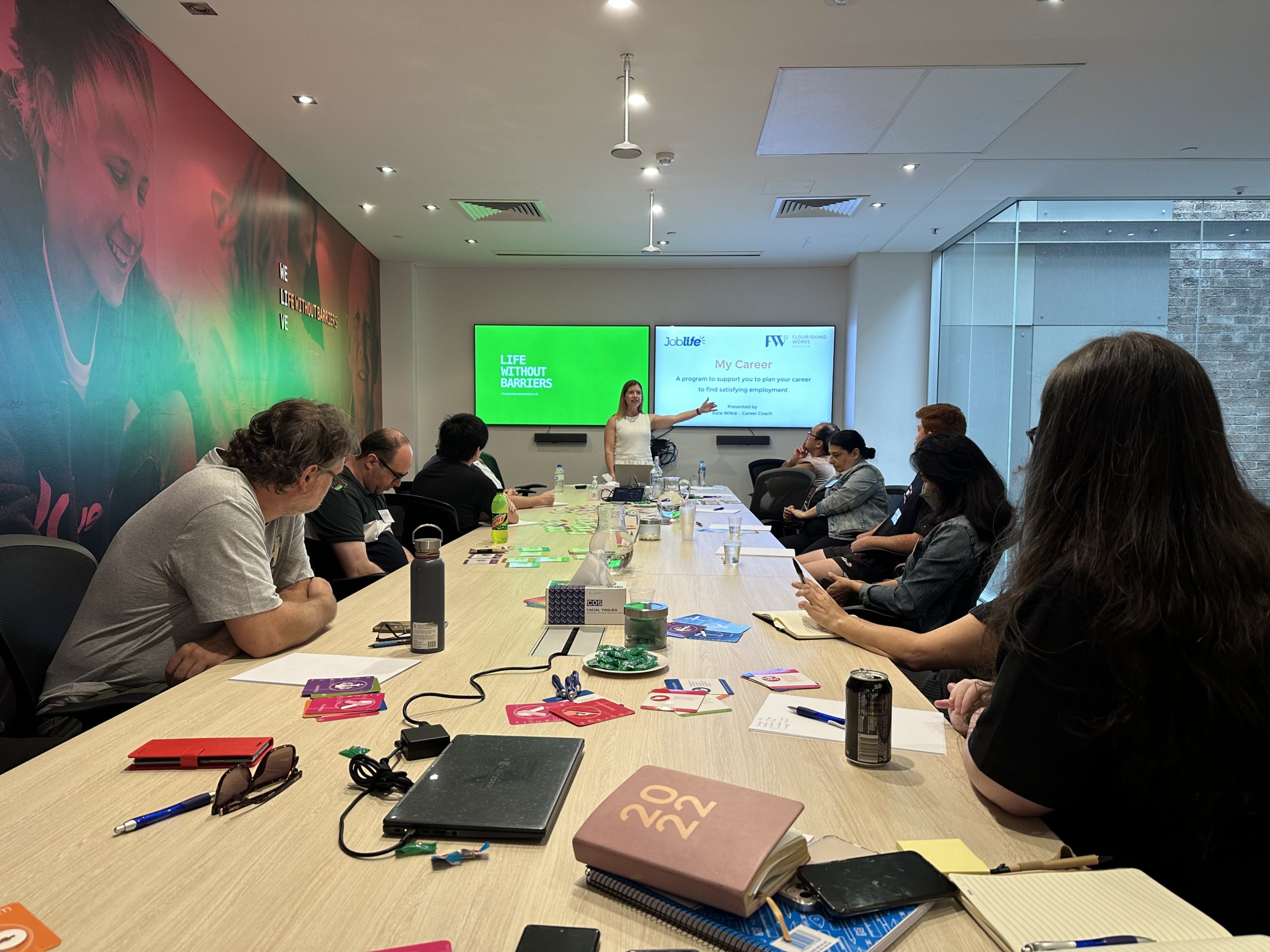 uLaunch - photo of a group of workers listening to a presenter in a board room