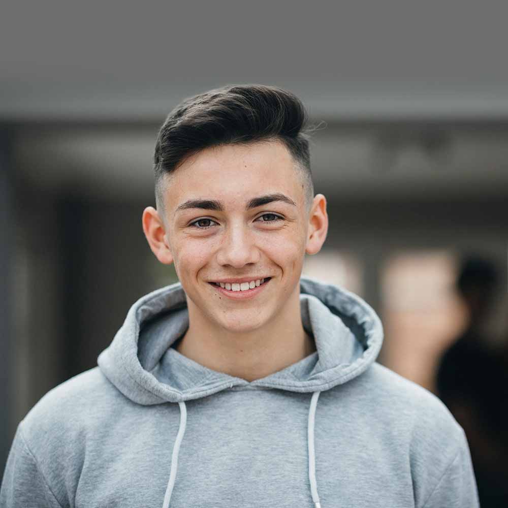 uLaunch - Young people - photo of a young man smiling and wearing a grey hoodie