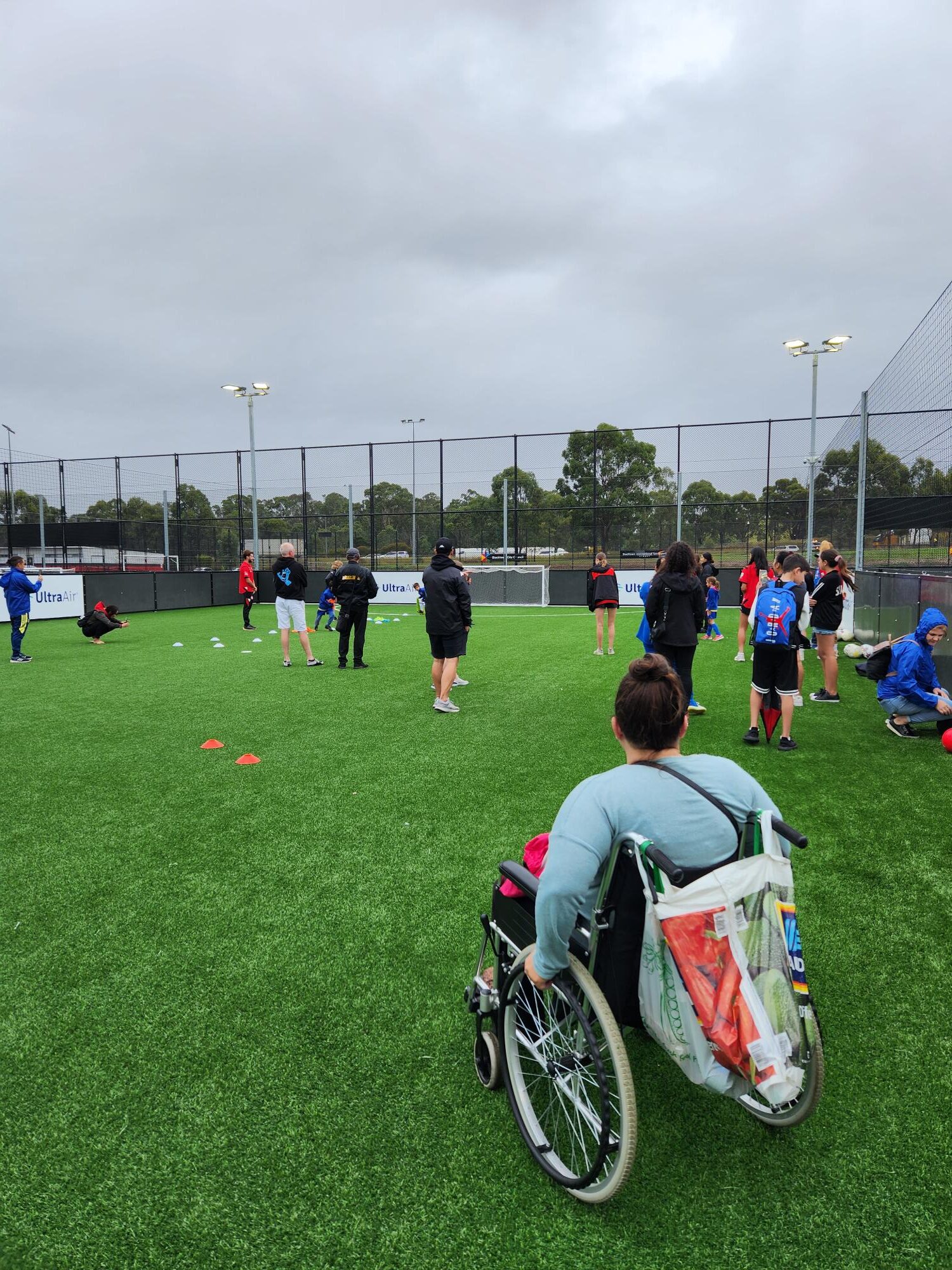 uLaunch - photo of a women in a wheelchair involved in community sport