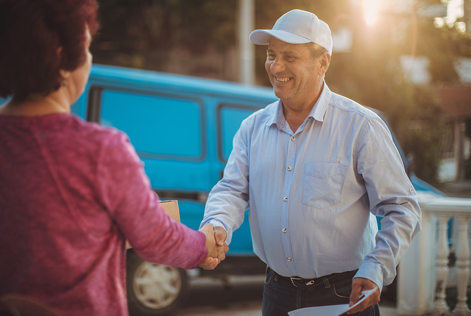 Image of a man shaking hands with a women outdoors