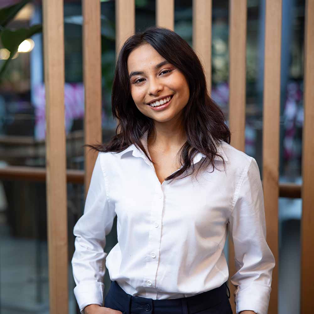 ULaunch-contact-us - A women in a white shirt smiling