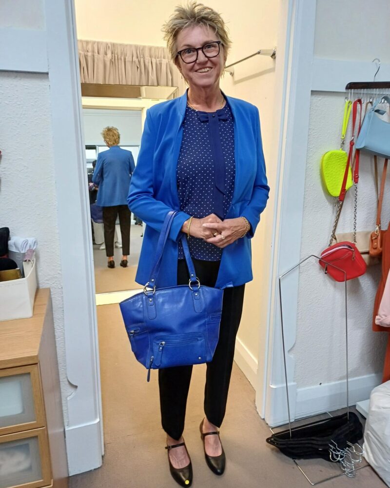 lee ann modeling a blue jacket and bag